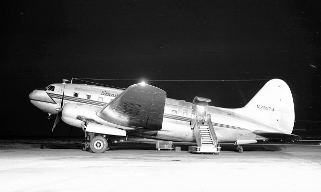 Another of Bill Larkins' outstanding night shots.  This one was taken at Oakland on 6 May 1949
                                     using his Kodak Super-XX 616 camera on f.8 with the shutter open for three minutes (no flash).
                                     Standard Air Lines was founded in 1948 and had no relation to Standard Airways formed from
                                     Standard Air Cargo in 1953.  Standard Air Lines operated low fare irregular scheduled passenger
                                     flights between Burbank, Long Beach and Oakland in California and New York (Newark) via
                                     Kansas City and Chicago.   DC-3s and C-46s were used.   In 1950* it merged with Ross Hart
                                     and Jack Lewin's Viking Air Lines to form North American Airlines. 
                                     N79978 was a former C-46E-1-CS (43-47410) acquired by Standard in April 1948.  On 12 July
                                     1949 the aircraft departed Albuquerque at 04:24 hrs for a flight to Burbank, CA.      At 07:36 the
                                     crew were cleared to land at Burbank; but nothing more was heard from the flight.    It appeared
                                     that the C-46 had crashed on approach, striking the ground at 1890 feet asl, some 430 feet below
                                     the crest of Santa Susana Pass.  32 of the 44 passengers and 3 of a crew of 4 died in the accident.
                                     * As a result of the crash Standard Airlines was ordered to cease non-scheduled operations due to
                                     regulation violations and shortly afterward sold out to North American, as stated above. 